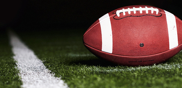 Football on Turf Near Goal Line at Night