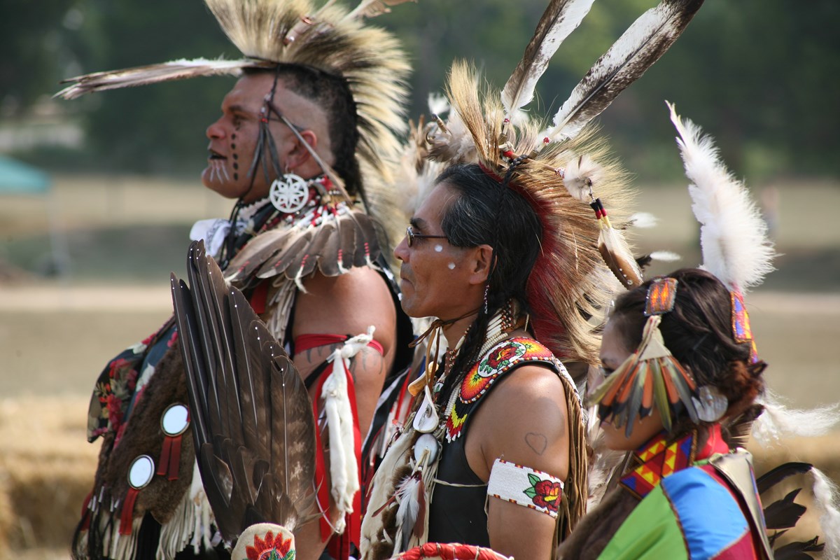 Native Americans in Traditional Garb Preparing for Dance at Pow Wow, adapted from image at nps.gov