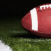 Football on Turf Near Goal Line at Night