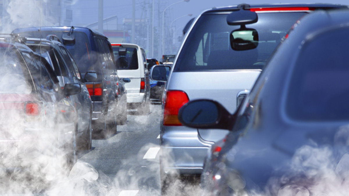 Vehicles stopped on road in traffic jam with visible smoky emissions, adapted from cdc.gov image
