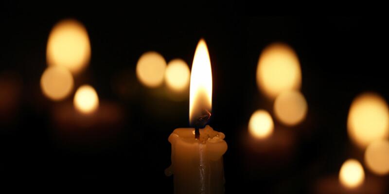 File photo of candles burning against dark background, adapted from ice.gov image