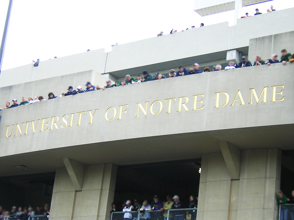 University of 'Notre Dame' Stadium Facade with engraved name and fans